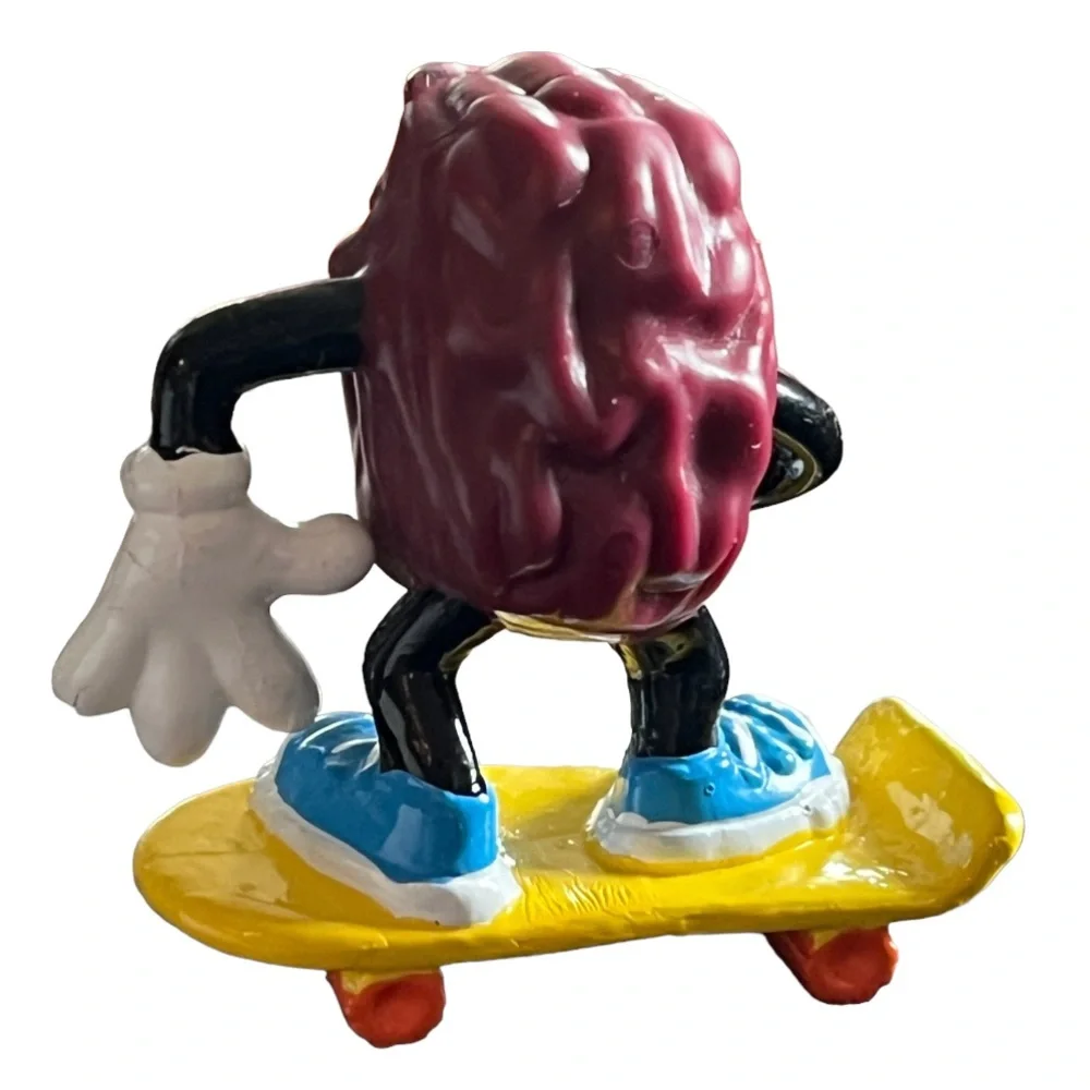 Vintage 1980s California Raisins Figure Riding a Skateboard Cake Topper